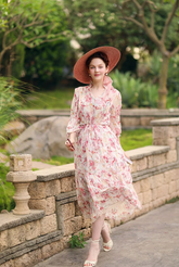 a lady in a pink floral printed dress